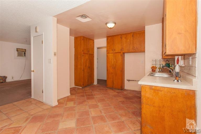 445 Charles Street Moorpark, CA 93021 - Photo 15 of 24 a view of a kitchen with a sink and a refrigerator