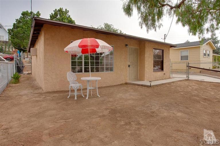 445 Charles Street Moorpark, CA 93021 - Photo 9 of 24 a table and chair in front of a house