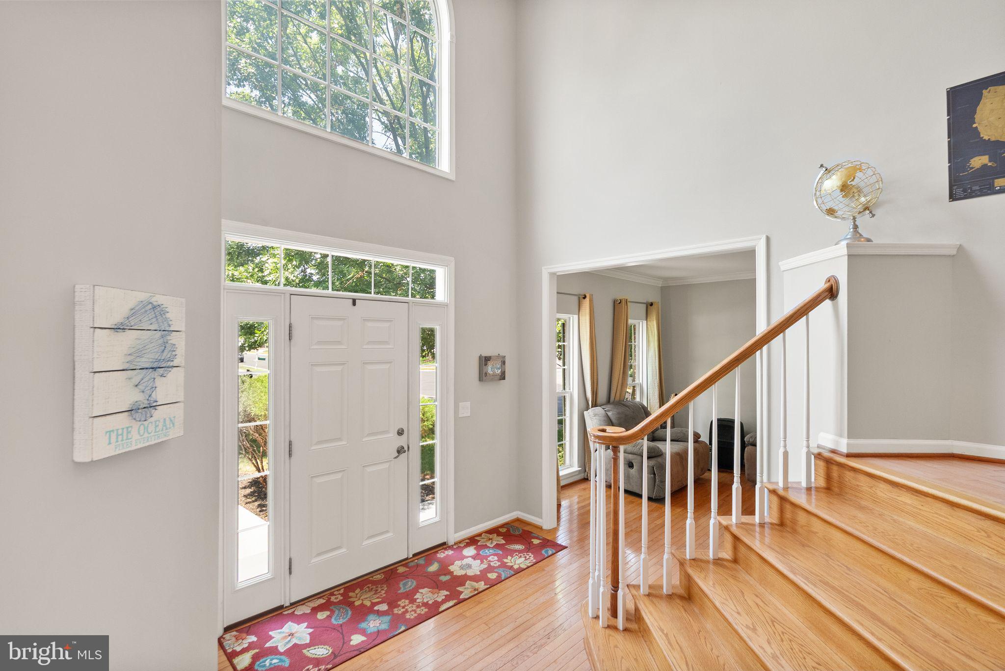 6901 Bitterroot Court Gainesville, VA 20155 - Photo 12 of 98 a view of entryway with wooden floor and stairs