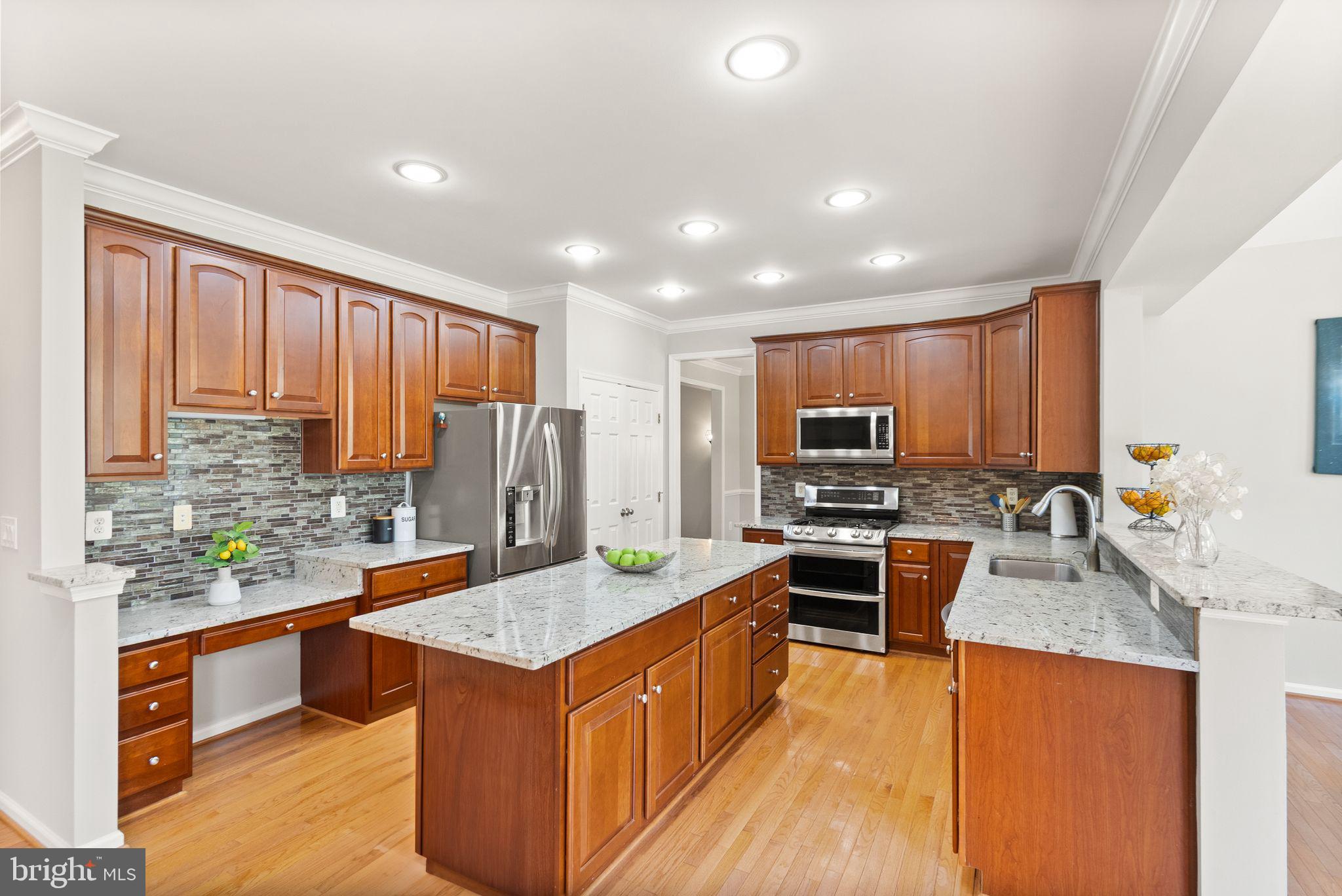 6901 Bitterroot Court Gainesville, VA 20155 - Photo 20 of 98 a kitchen with stainless steel appliances granite countertop a stove top oven a sink dishwasher a refrigerator and a oven