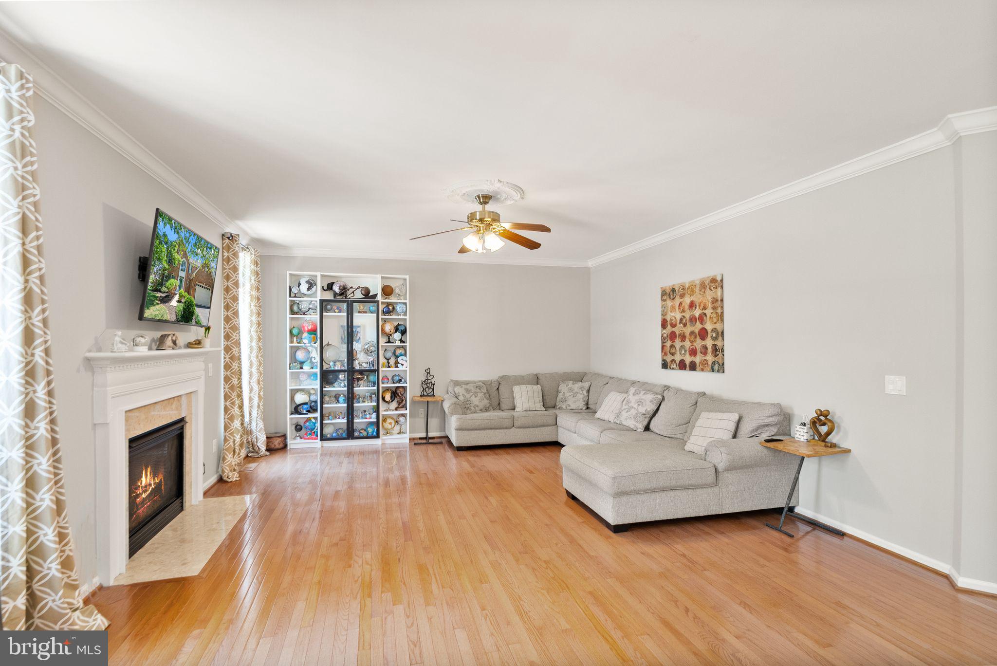 6901 Bitterroot Court Gainesville, VA 20155 - Photo 25 of 98 a living room with furniture and a fireplace