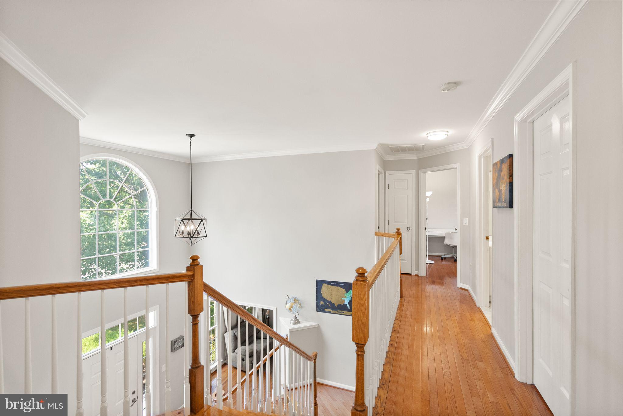 6901 Bitterroot Court Gainesville, VA 20155 - Photo 30 of 98 a view of a hallway with wooden floor and staircase