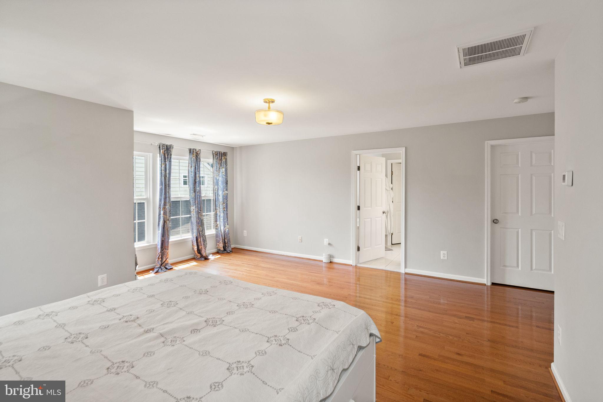 6901 Bitterroot Court Gainesville, VA 20155 - Photo 32 of 98 a view of an empty room with wooden floor and a window