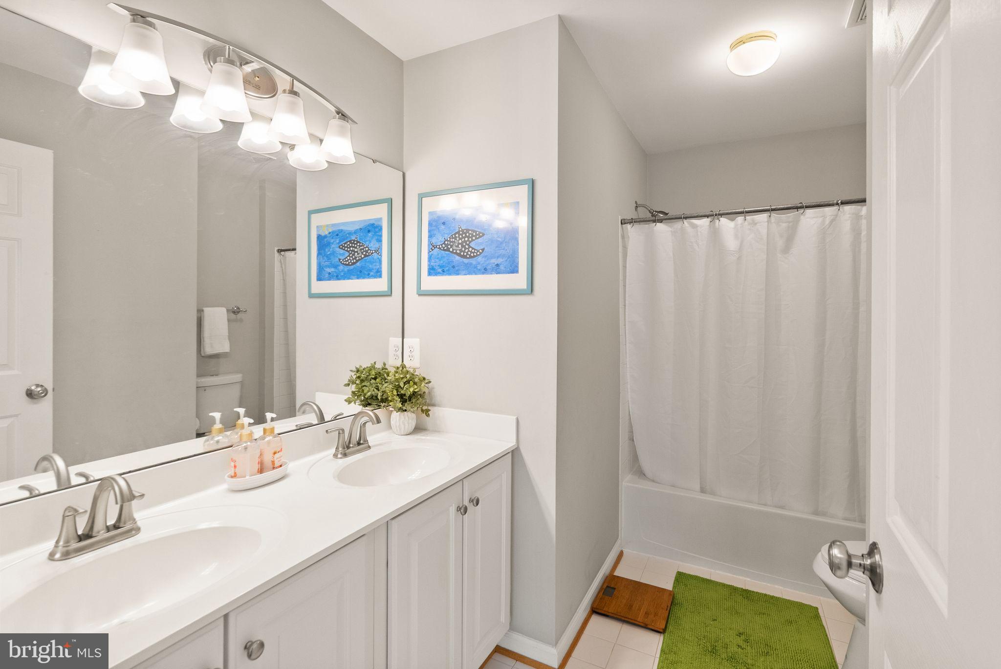 6901 Bitterroot Court Gainesville, VA 20155 - Photo 48 of 98 a bathroom with a sink and a mirror