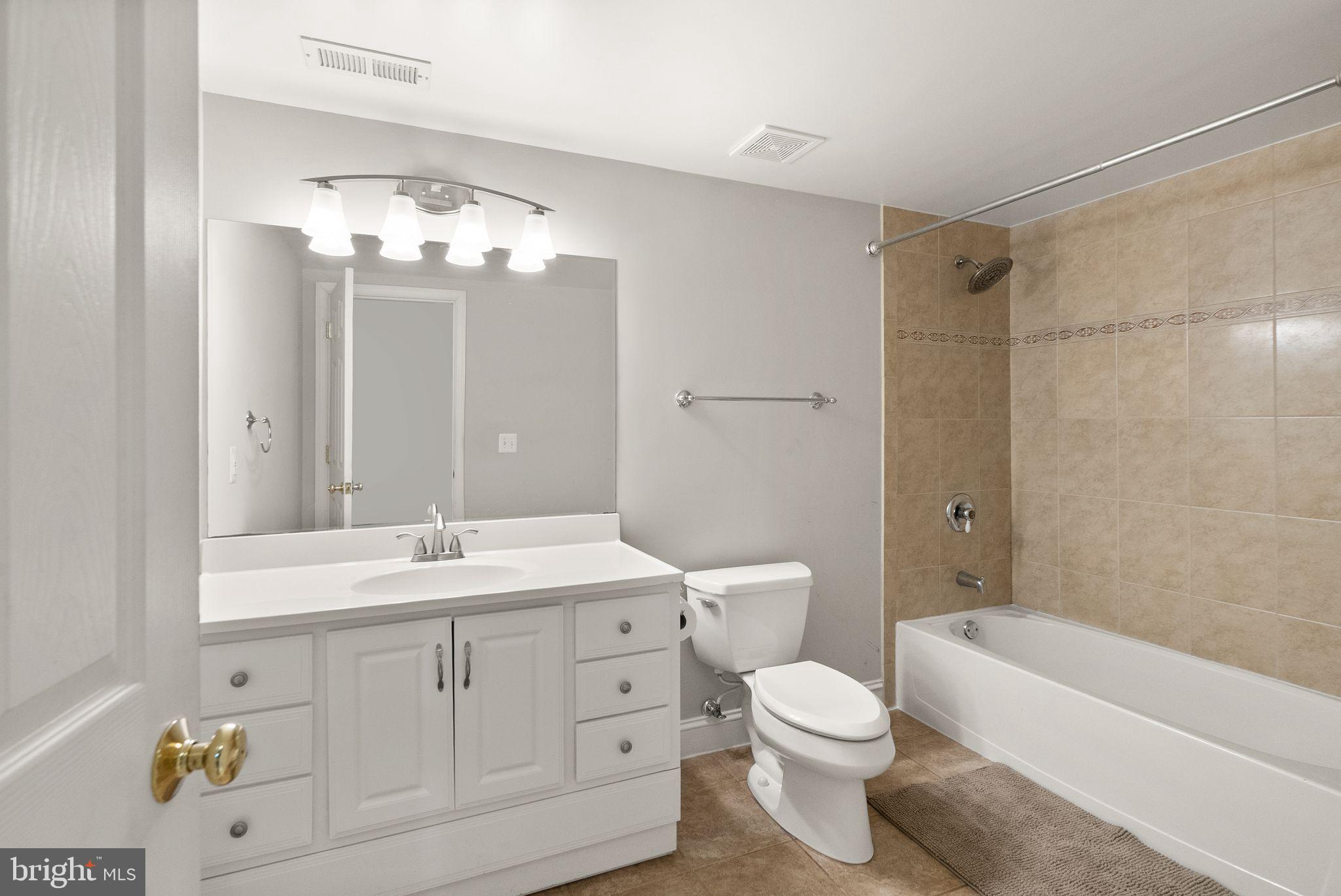 6901 Bitterroot Court Gainesville, VA 20155 - Photo 60 of 98 a bathroom with a toilet a bath tub a sink and mirror