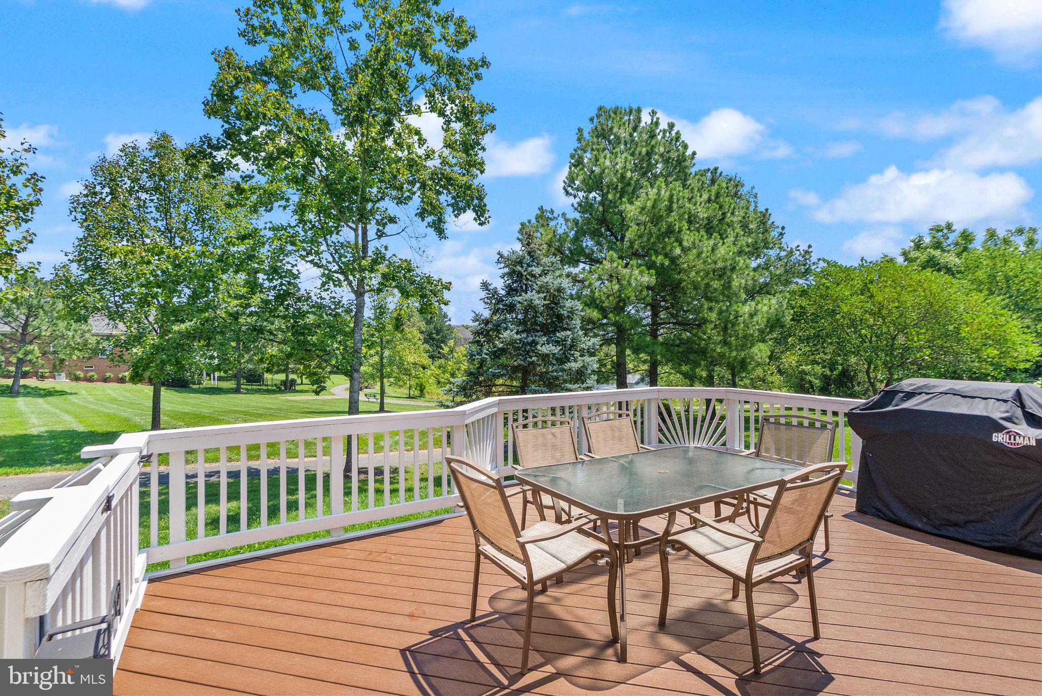 6901 Bitterroot Court Gainesville, VA 20155 - Photo 61 of 98 a view of a deck with a table and chairs with wooden floor