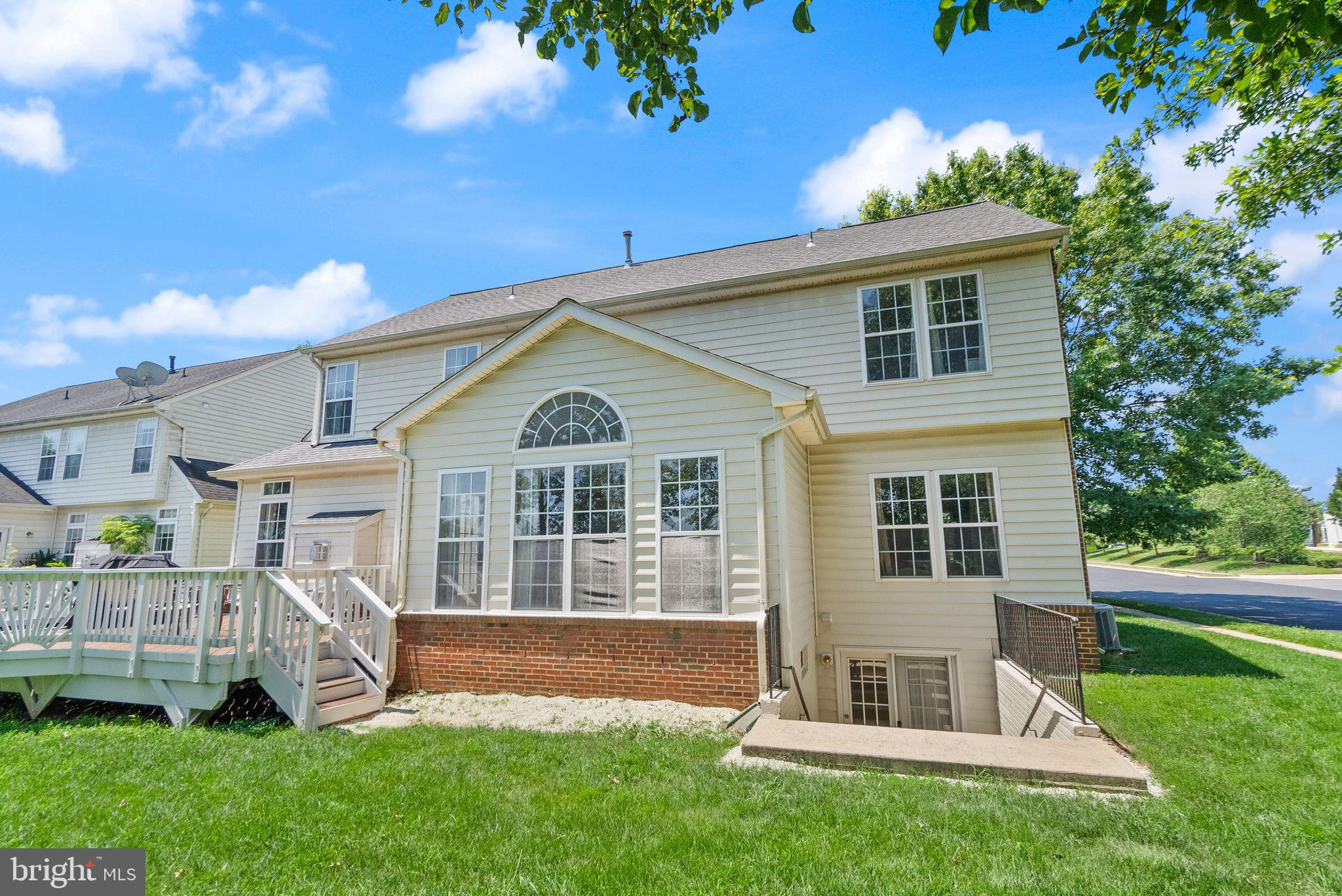 6901 Bitterroot Court Gainesville, VA 20155 - Photo 64 of 98 a front view of a house with a yard and garage