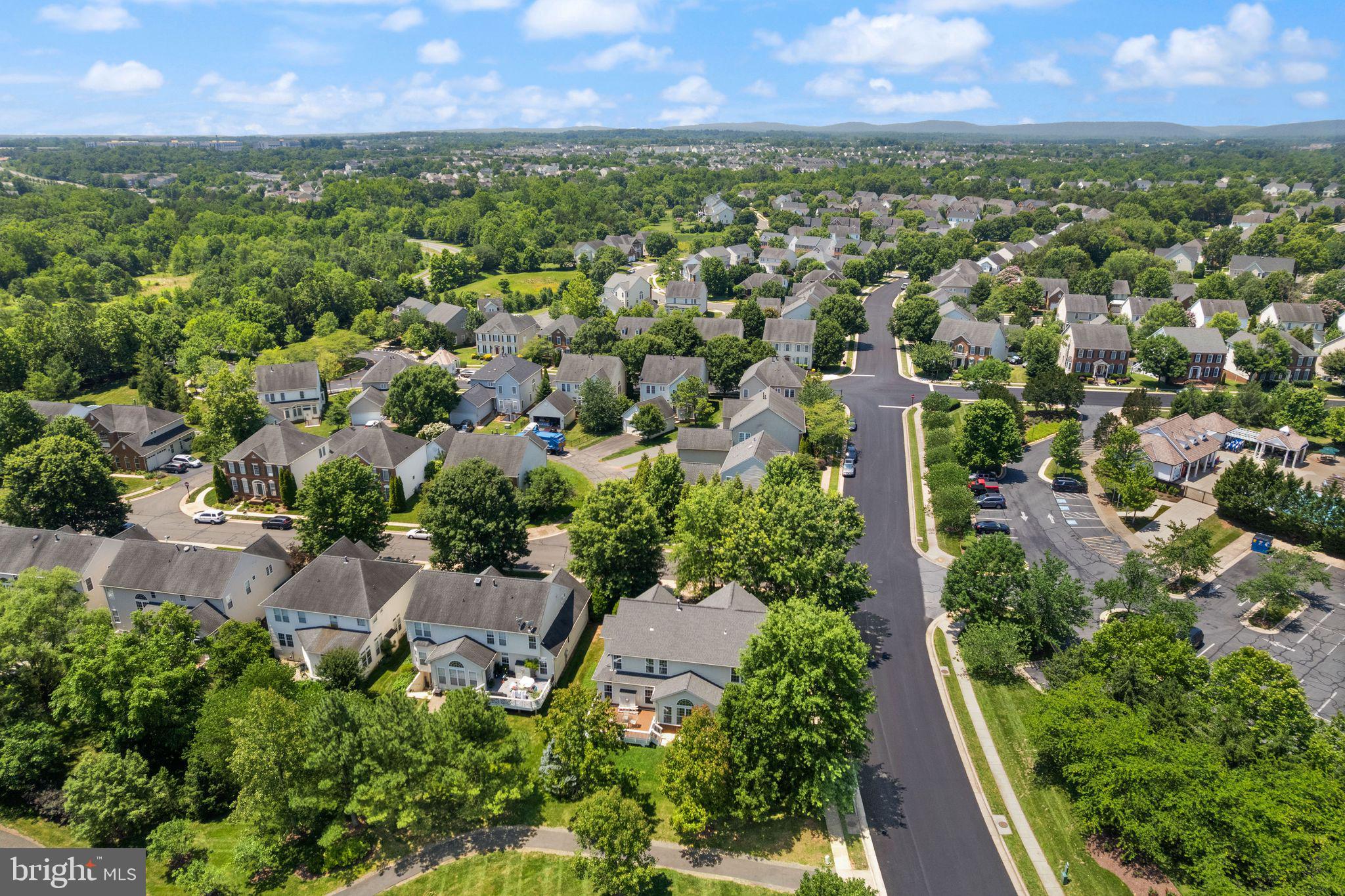 6901 Bitterroot Court Gainesville, VA 20155 - Photo 72 of 98 an aerial view of residential houses with outdoor space and trees
