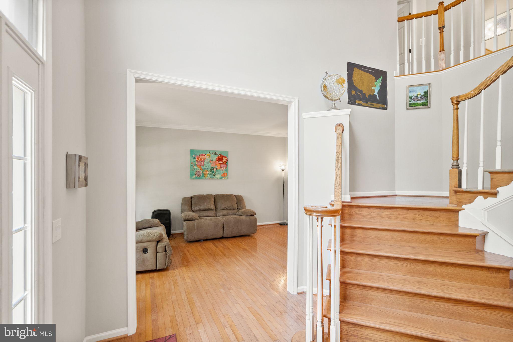 6901 Bitterroot Court Gainesville, VA 20155 - Photo 10 of 98 a living room with furniture and a wooden floor