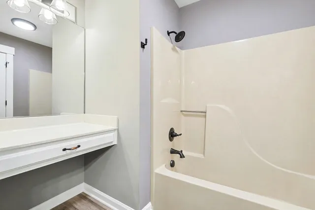 a bathroom with a tub and a shower