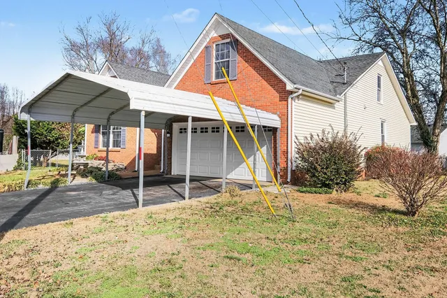 a view of a house with backyard and sitting area