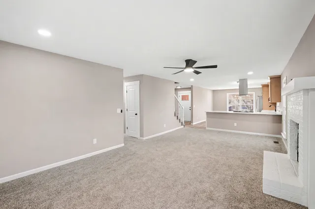 a view of a kitchen with a sink and a refrigerator