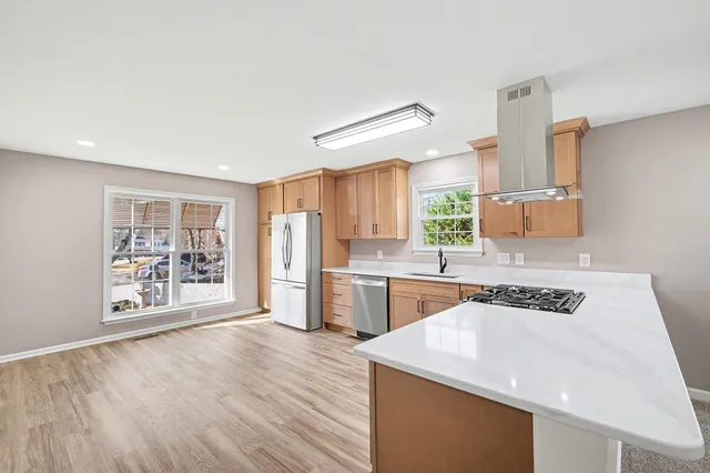 a kitchen with granite countertop a stove and a refrigerator