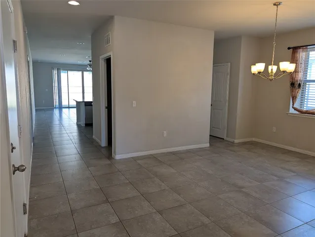 a view of a hallway with a chandelier