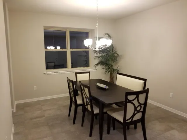 a view of a dining room with furniture and window