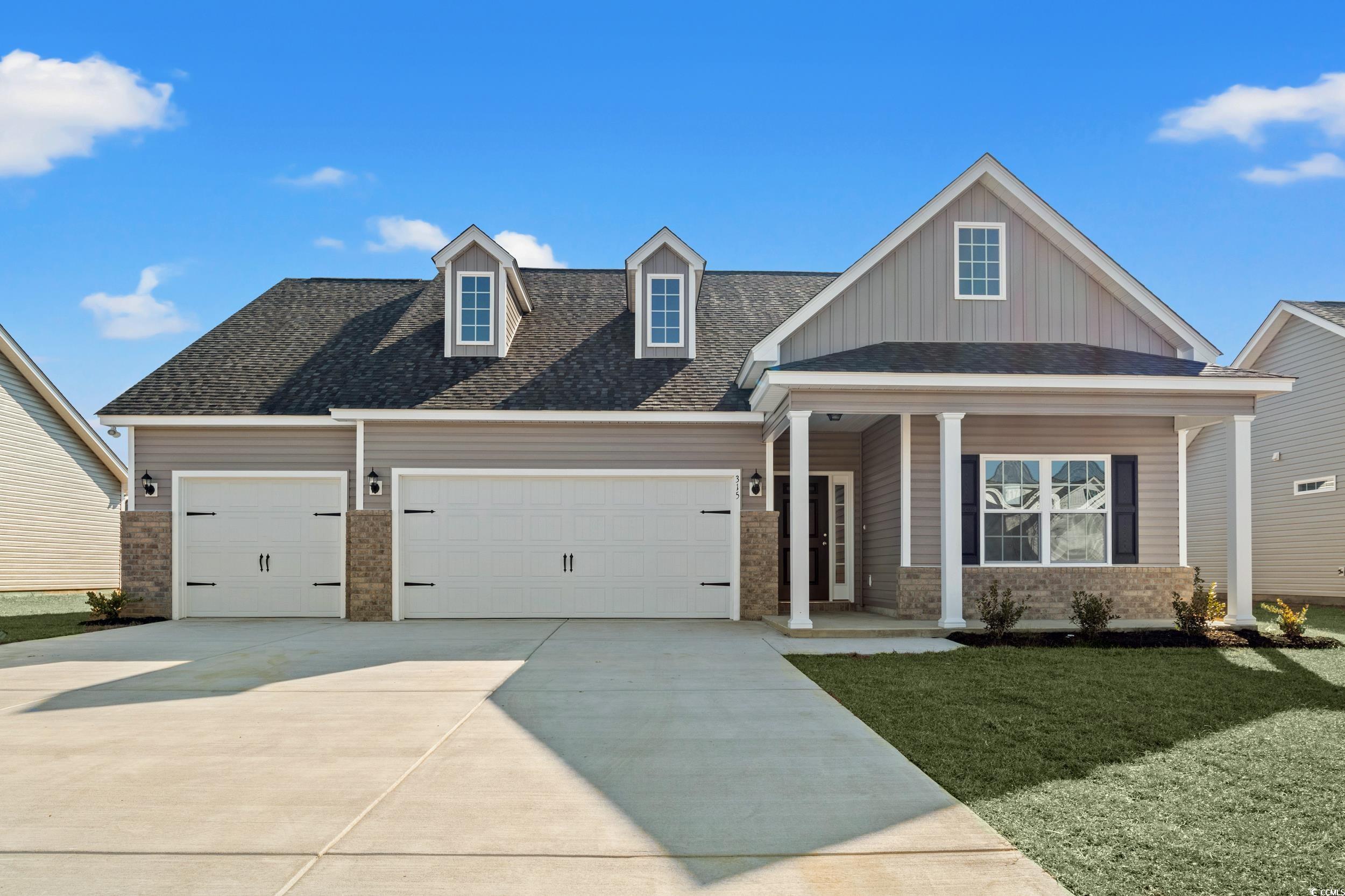 609 Bay Street Aynor, SC 29544 - Photo 1 of 17 View of front of house with a porch, a garage, a front yard, roof with shingles, and driveway