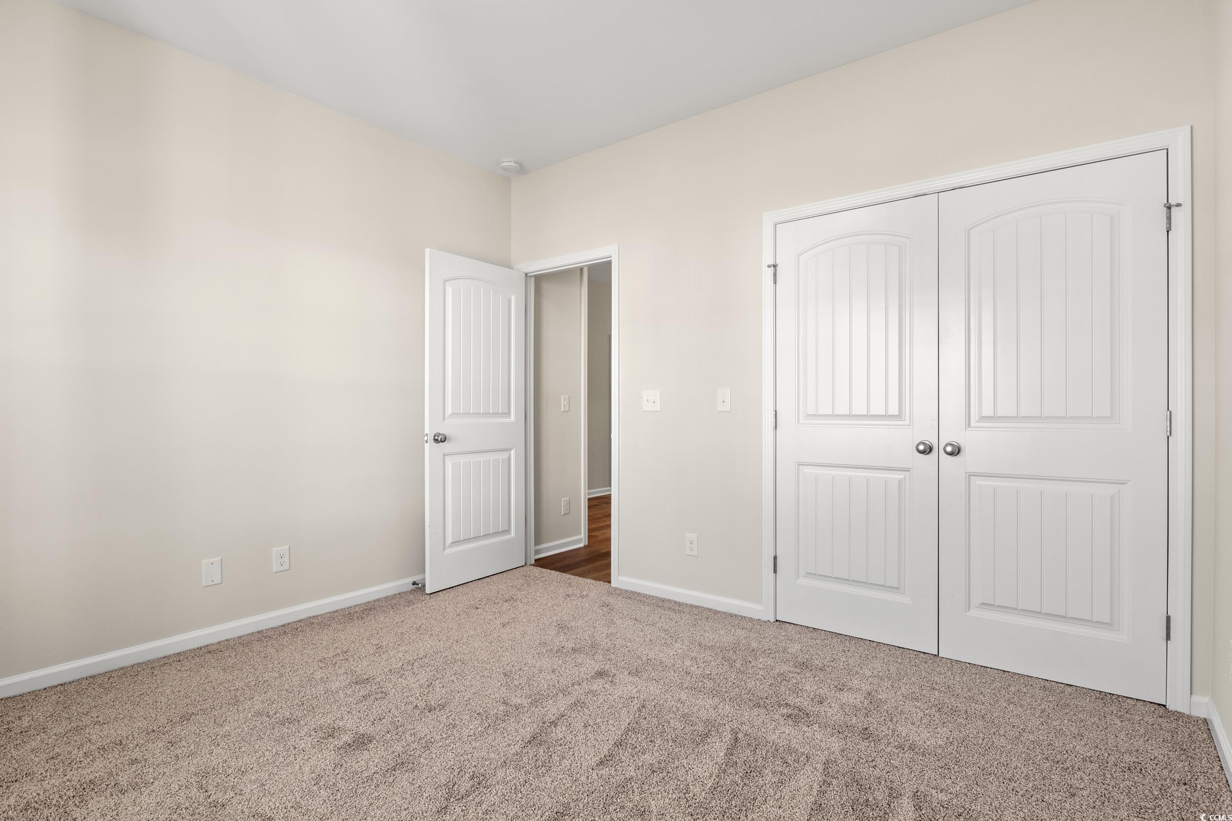 609 Bay Street Aynor, SC 29544 - Photo 3 of 17 Unfurnished bedroom featuring carpet flooring and a closet