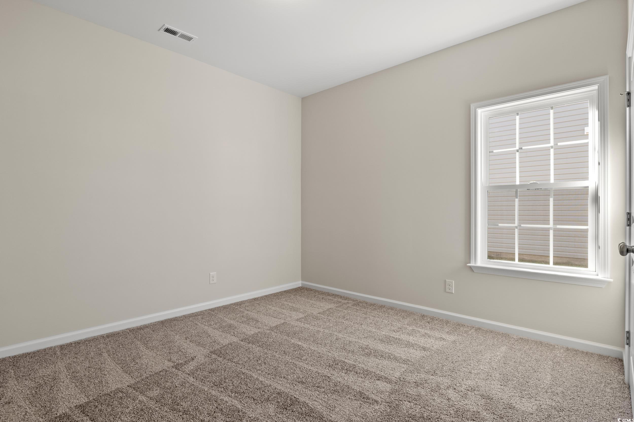 609 Bay Street Aynor, SC 29544 - Photo 5 of 17 Spare room with baseboards and light carpet