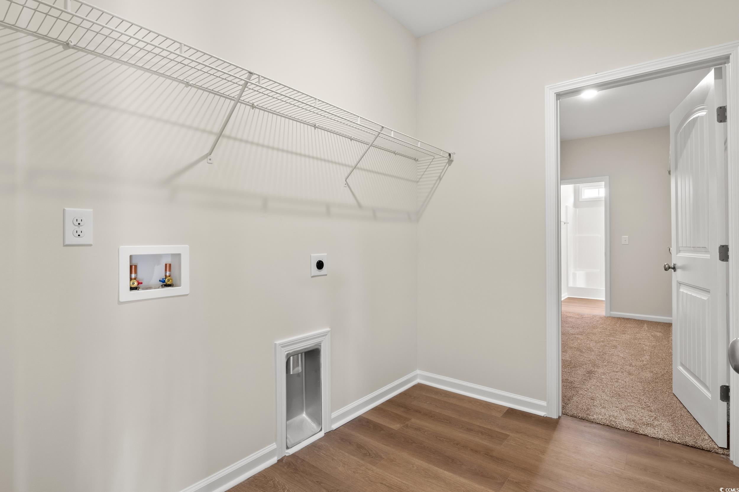 609 Bay Street Aynor, SC 29544 - Photo 7 of 17 Laundry area featuring wood finished floors, washer hookup, and electric dryer hookup