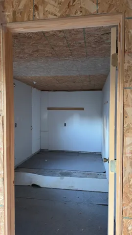 a view of a livingroom with an empty space and a window