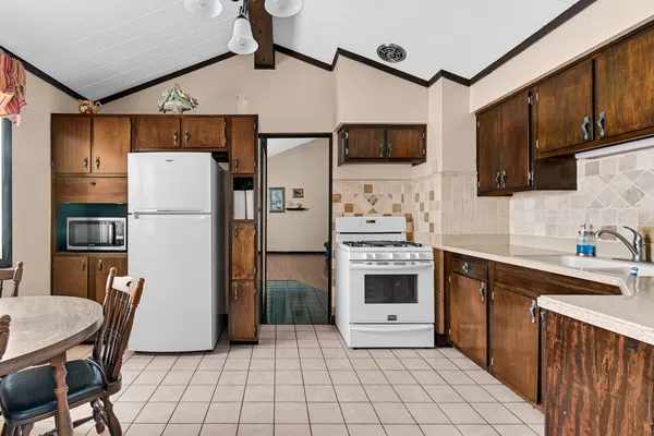 a kitchen with stainless steel appliances a refrigerator stove microwave and cabinets
