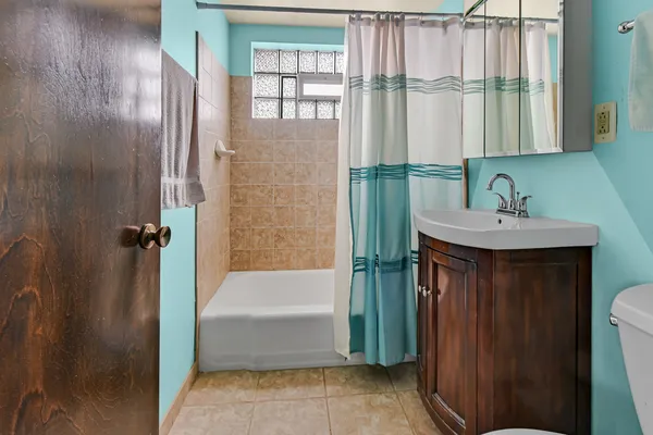 a bathroom with a sink a mirror and a bathtub