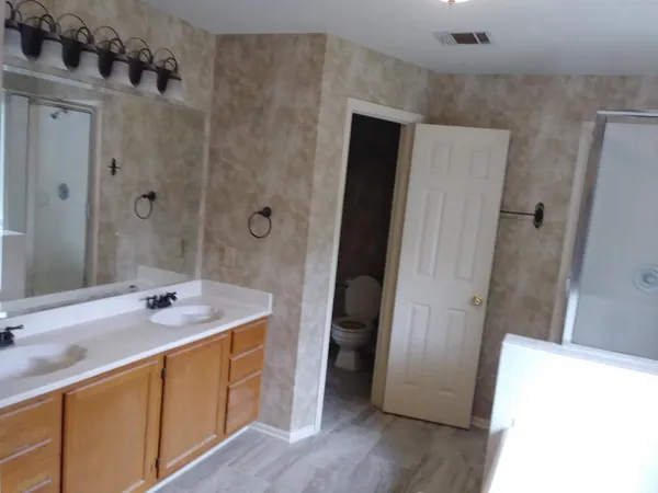 a bathroom with a sink a shower and a mirror