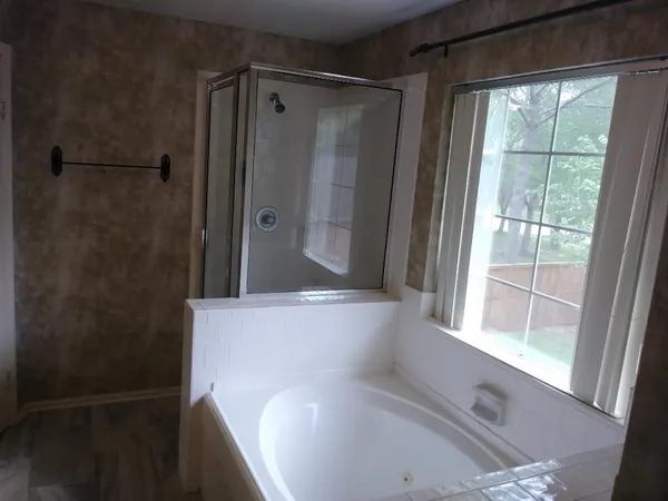a view of bathroom with shower and window