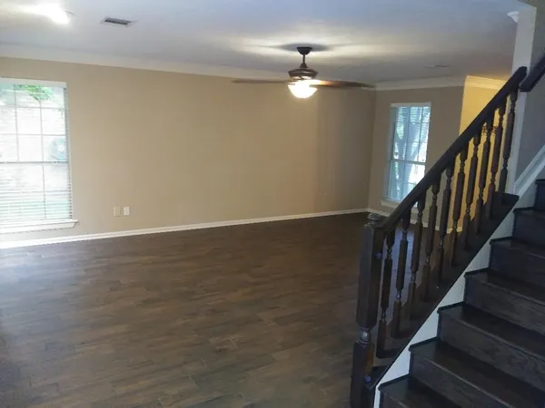 wooden floor in an empty room with a window