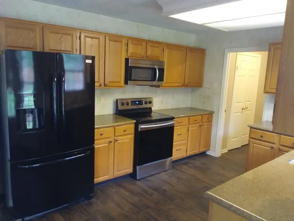 a kitchen with stainless steel appliances a refrigerator stove and sink