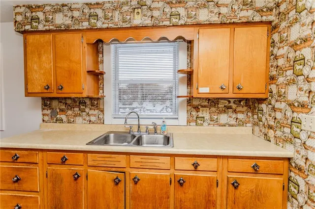a kitchen with a sink and a window