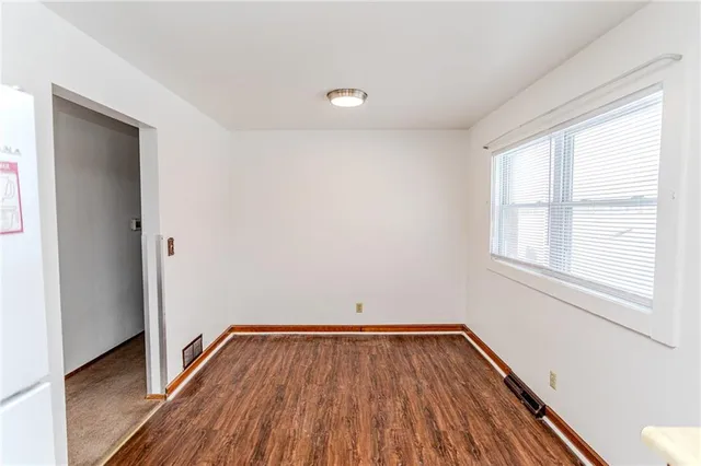 a view of a room with wooden floor and window