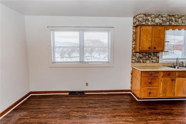a view of room with window and wooden floor