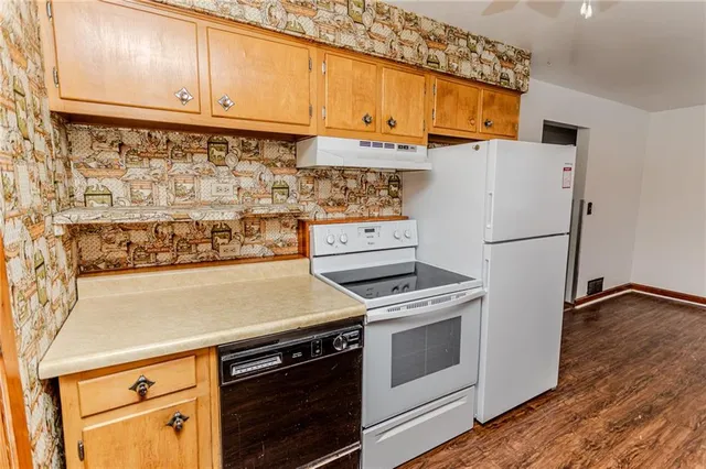 a kitchen with stainless steel appliances and white cabinets