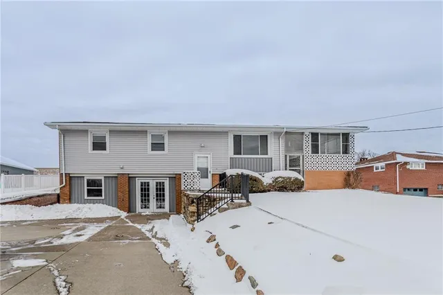 a bedroom with furniture and a large window