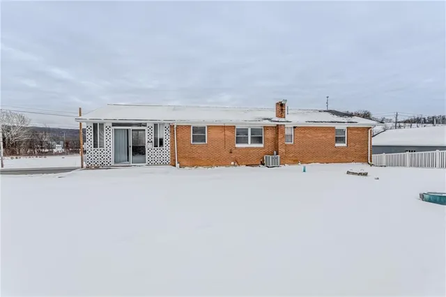 a front view of a house with large windows