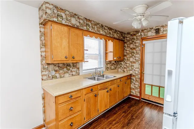 a kitchen with stainless steel appliances a sink and cabinets