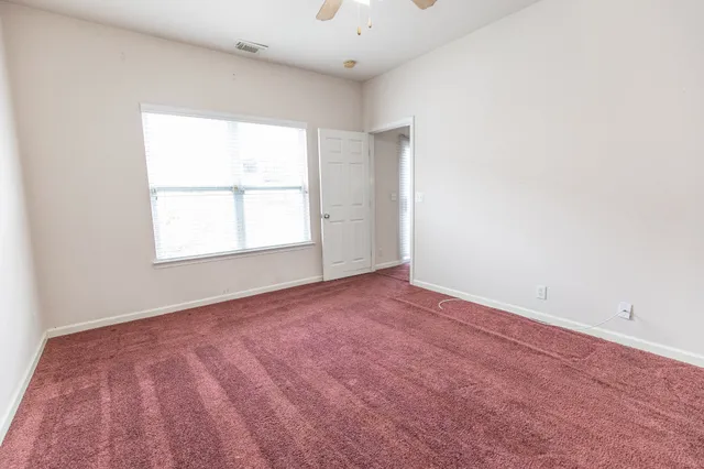 an empty room with a empty space and windows