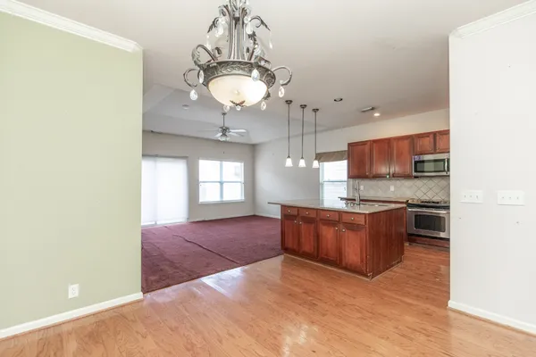 a large kitchen with stainless steel appliances granite countertop a stove and cabinets