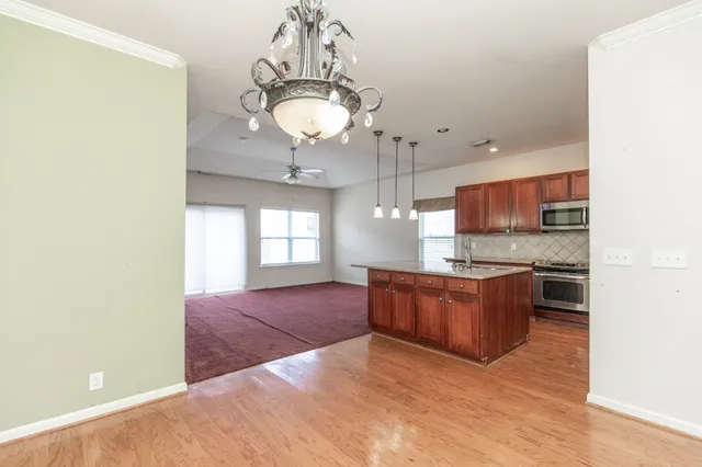 a large kitchen with stainless steel appliances granite countertop a stove and cabinets