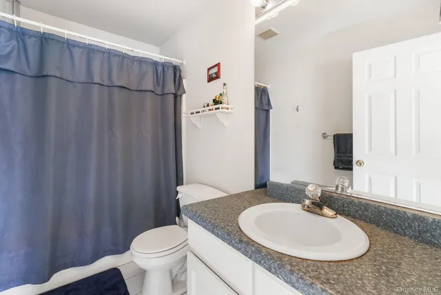 a spacious bedroom with a bed and a window