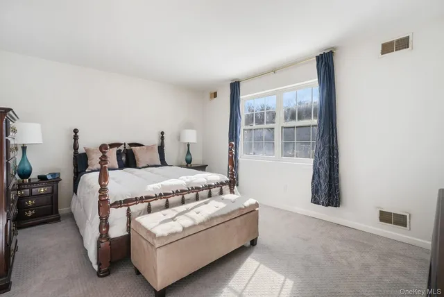 a bedroom with a bed and dresser