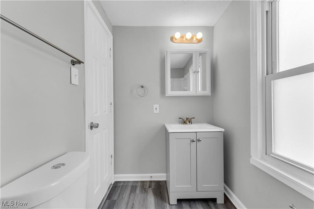 19600 Ridgewood Avenue Beachwood, OH 44122 - Photo 7 of 12 Bathroom featuring hardwood / wood-style floors, vanity, and toilet