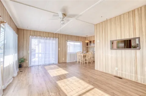 a view of a livingroom with wooden floor and furniture