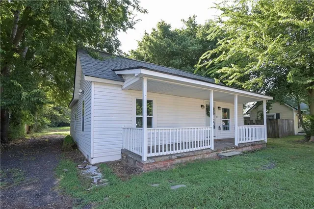 a view of a house with a yard and deck