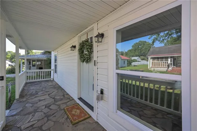 a view of a porch with wooden floor