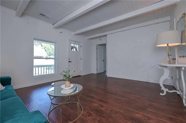 a view of a room with furniture and wooden floor