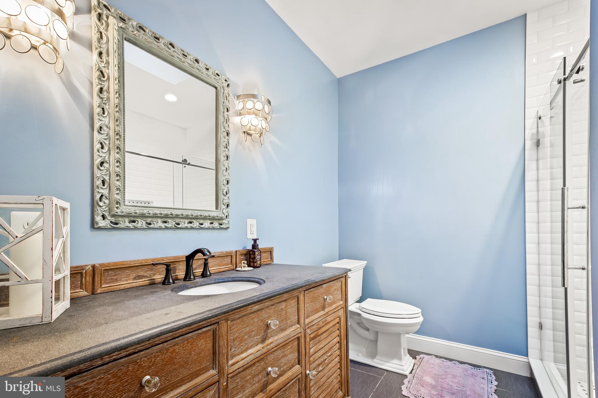 14 Midvale Road Baltimore, MD 21210 - Photo 27 of 91 a bathroom with a granite countertop sink a toilet and a mirror