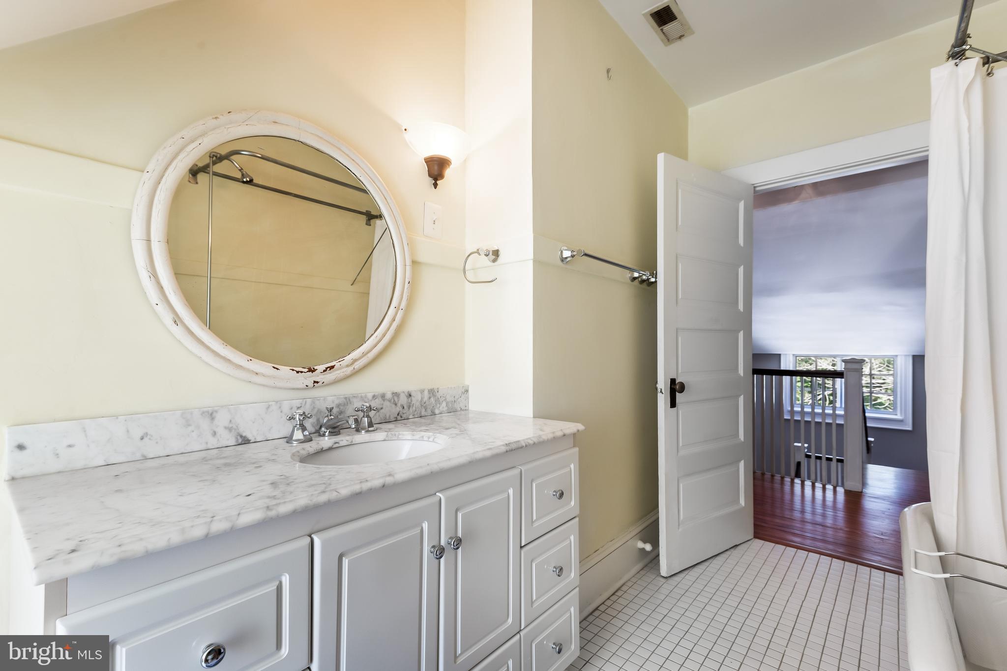 14 Midvale Road Baltimore, MD 21210 - Photo 62 of 91 a en suite bathroom with a granite countertop double vanity sink and a mirror