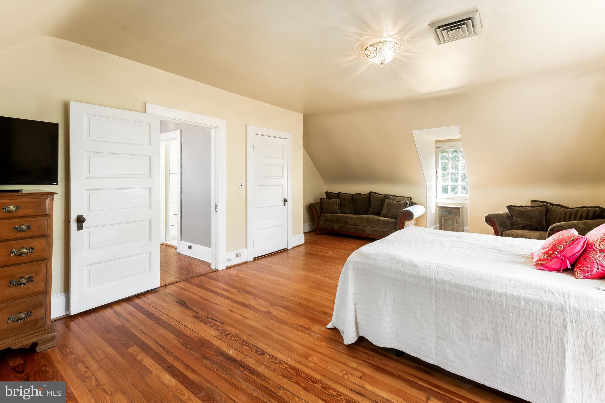 14 Midvale Road Baltimore, MD 21210 - Photo 65 of 91 a bedroom with a bed and wooden floor